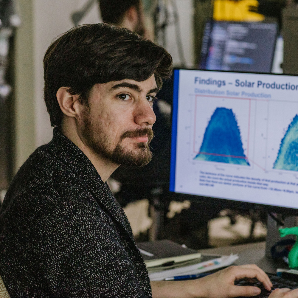 Male researcher in lab showcasing latest research statistics on computer