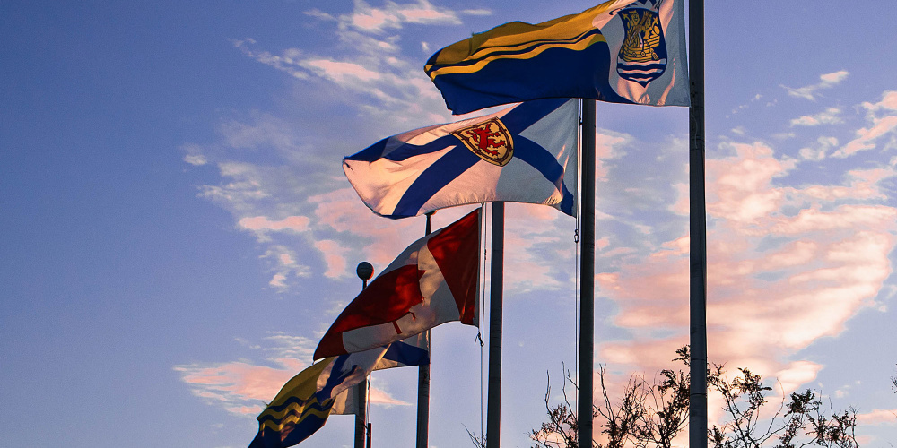 Nova Scotia flag waving in the wind at dusk by Halifax Harbour.